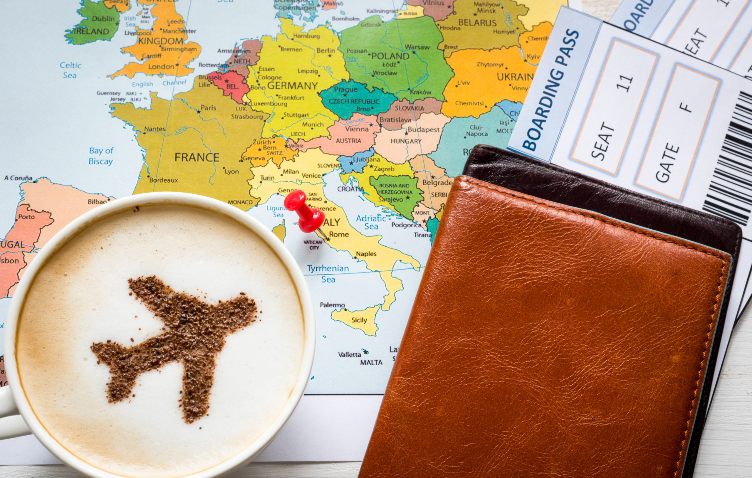 Airplane made of cinnamon in cappuccino, Passports and Europe map